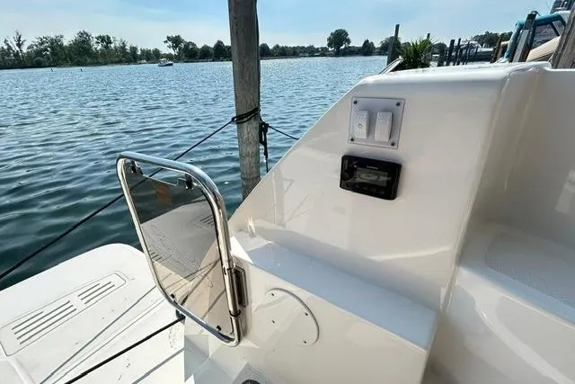 Slide: The Image of 2017 Sea Ray Sundancer 400 yacht docked by serene waters. - 32