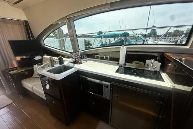 Slide: The Image of Luxurious 2017 Sea Ray Sundancer 400 yacht interior with modern kitchen amenities. - 14