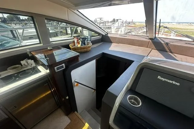 Slide: The Image of Interior view of 2017 Sea Ray Sundancer 400 yacht with kitchen and navigation area. - 18
