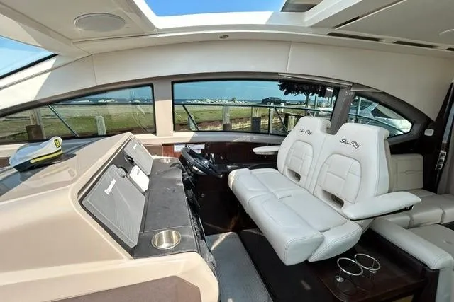 Slide: The Image of 2017 Sea Ray Sundancer 400 yacht interior with plush seating and modern helm controls. - 42