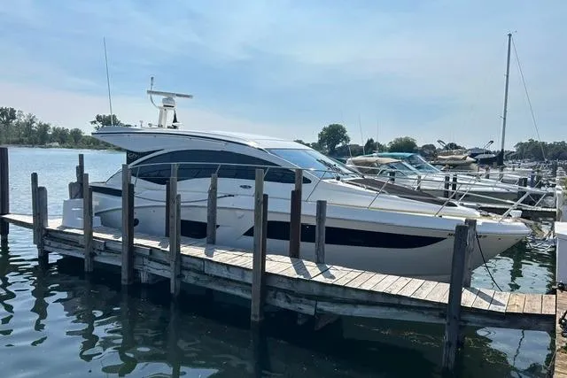 The Image of 2017 Sea Ray Sundancer 400 yacht docked at a marina on a sunny day. - 1