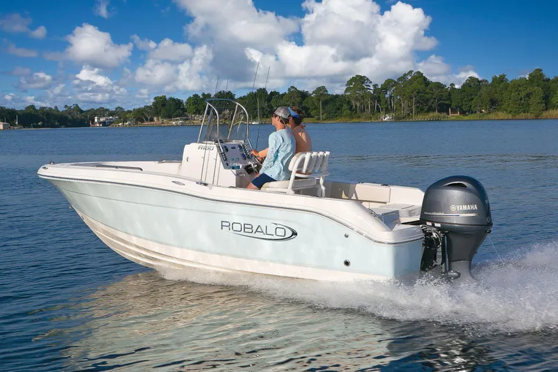 Slide: The Image of Manufacturer Provided Image: 2021 Robalo R180 Center Console boat cruising on a lake. - 14