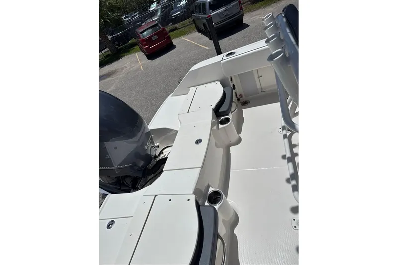 Slide: The Image of 2021 Robalo R180 Center Console boat interior with seating and motor view. - 9