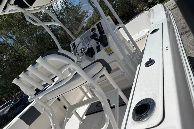 Slide: The Image of 2021 Robalo R180 Center Console boat interior with seating and control panel. - 3