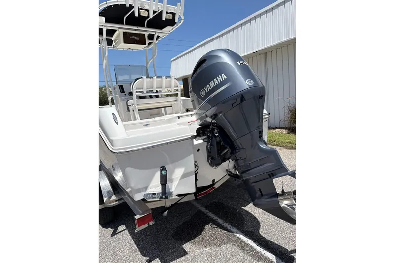 Slide: The Image of 2021 Robalo R180 Center Console boat with Yamaha outboard motor, parked outdoors. - 8