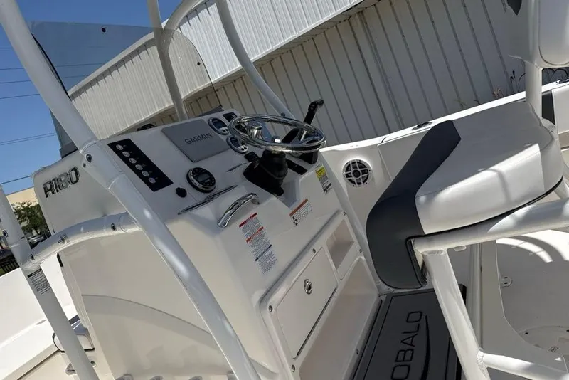 Slide: The Image of 2021 Robalo R180 Center Console boat interior with steering wheel and seating. - 6