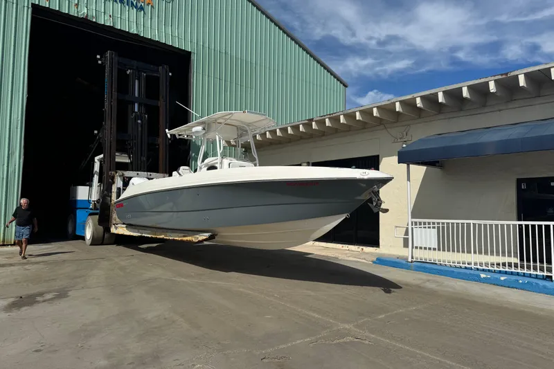 Slide: The Image of 2001 Wellcraft 29 Scarab boat being moved from a large storage facility. - 0