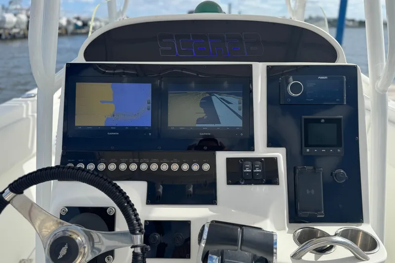 Slide: The Image of Center console of a 2001 Wellcraft 29 Scarab boat with navigation displays. - 11