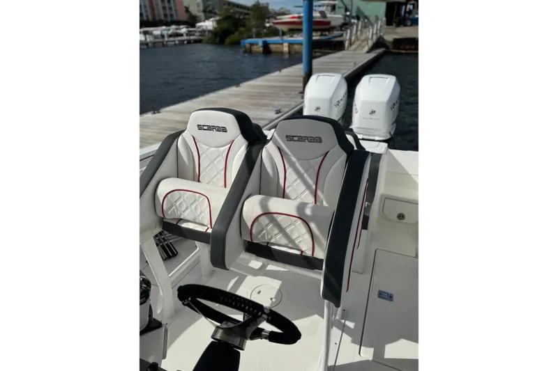 Slide: The Image of 2001 Wellcraft 29 Scarab boat interior with stylish seating and dual outboard engines. - 6
