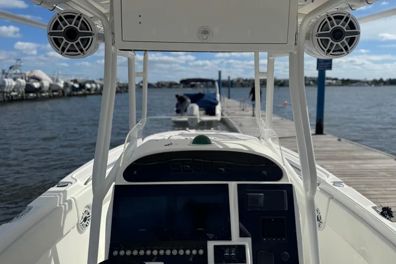 Slide: The Image of 2001 Wellcraft 29 Scarab boat docked, featuring a modern control panel and speakers. - 9