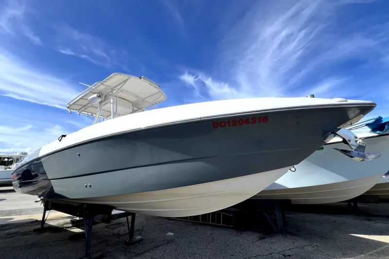 The Image of 2001 Wellcraft 29 Scarab boat on display under a clear blue sky. - 0
