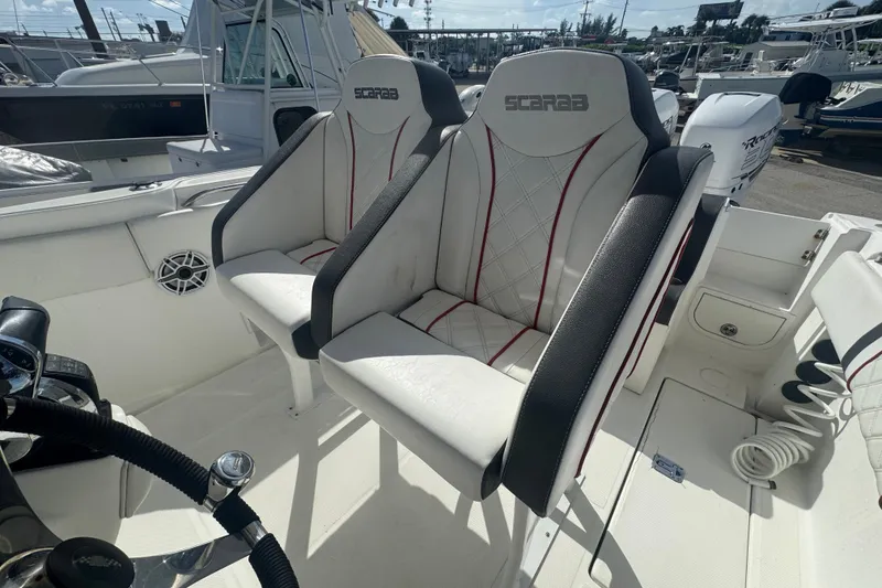 Slide: The Image of 2001 Wellcraft 29 Scarab boat interior with dual seats and steering wheel. - 32