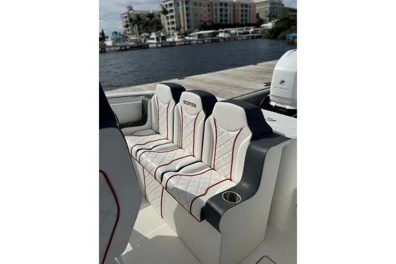 Slide: The Image of Wellcraft 29 Scarab 2001 boat seating with quilted upholstery, dockside view. - 7