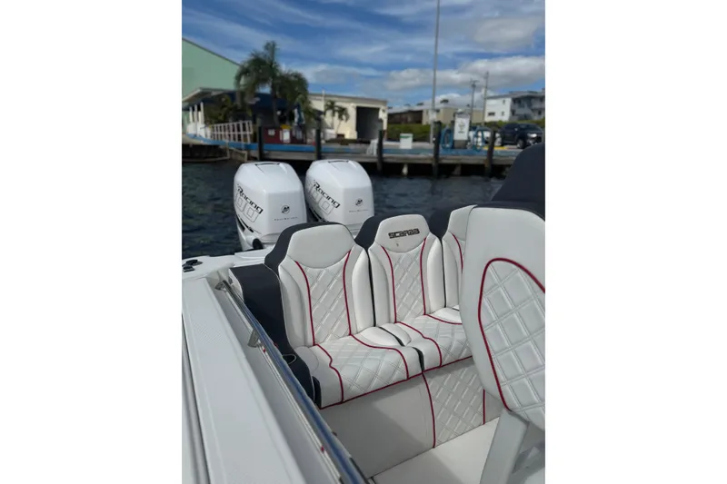 Slide: The Image of 2001 Wellcraft 29 Scarab boat with luxurious seating and twin Mercury Racing engines. - 8