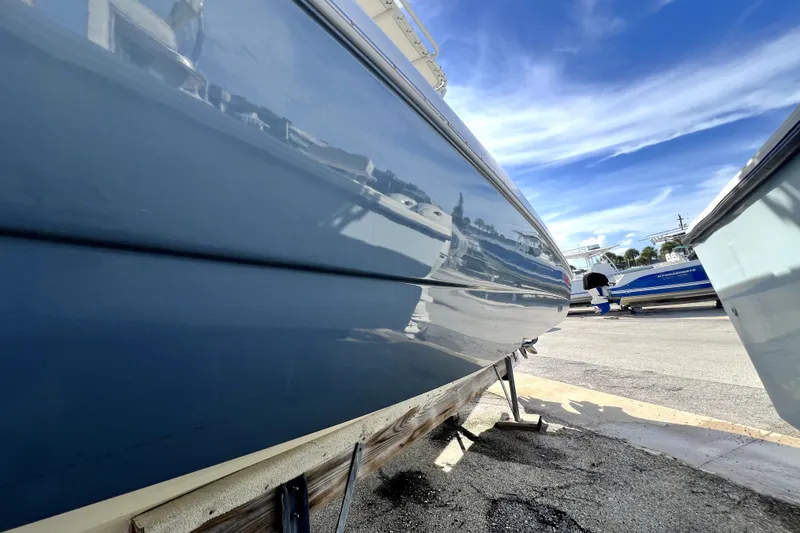 Slide: The Image of 2001 Wellcraft 29 Scarab boat on trailer under clear blue sky. - 22