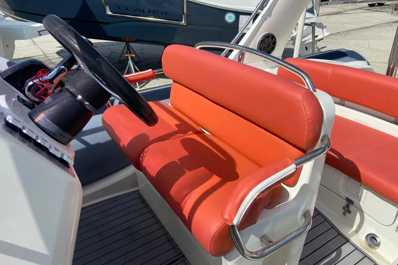 Slide: The Image of 2019 Brig Eagle 650 boat interior with red seating and steering wheel. - 10