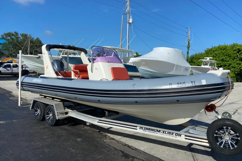 The Image of 2019 Brig Eagle 650 inflatable boat on trailer, parked outdoors under clear blue sky. - 0