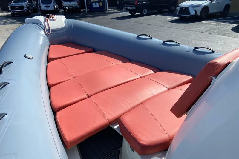Slide: The Image of 2019 Brig Eagle 650 boat with red cushioned seating in a parking lot. - 12