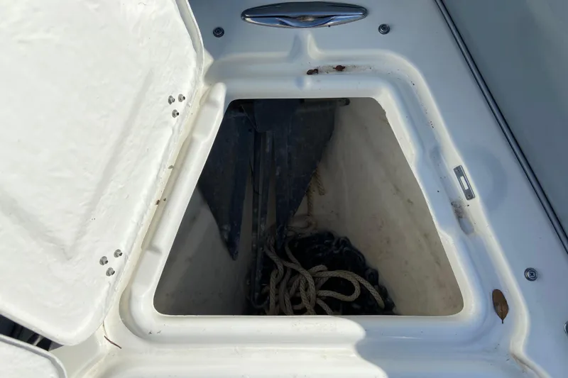 Slide: The Image of Open storage compartment on a 2019 Brig Eagle 650 boat, containing rope and anchor. - 17