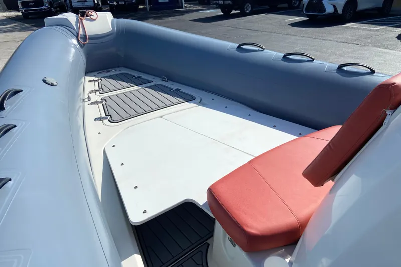 Slide: The Image of 2019 Brig Eagle 650 inflatable boat with red seating and spacious deck. - 13