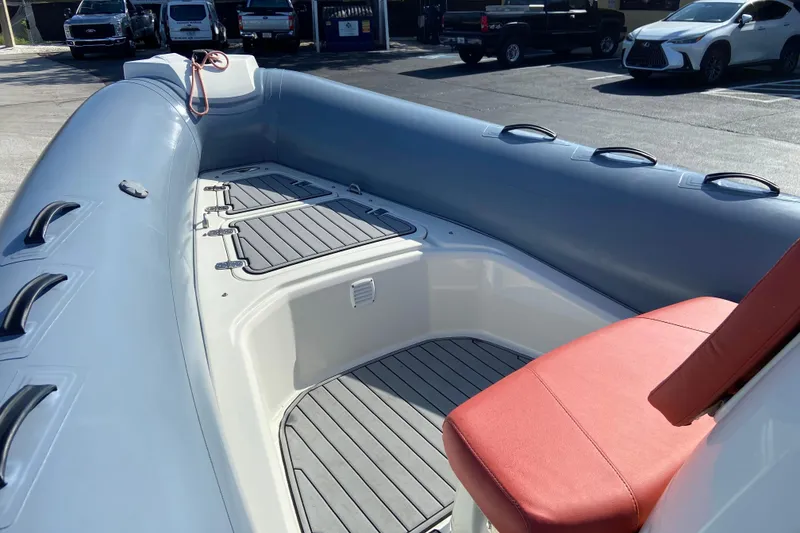 Slide: The Image of 2019 Brig Eagle 650 boat interior with red seating and gray flooring. - 14