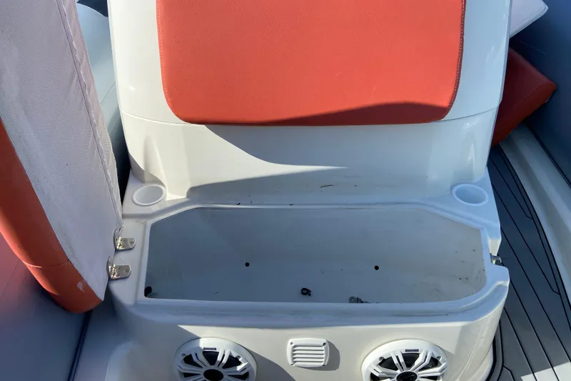 Slide: The Image of 2019 Brig Eagle 650 boat seat storage with red cushion and built-in speakers. - 19