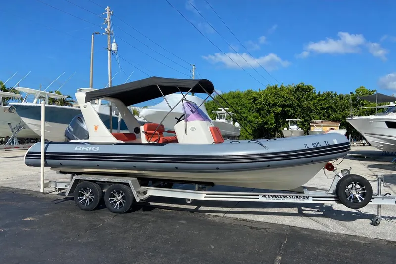 Slide: The Image of 2019 Brig Eagle 650 boat on trailer, parked outdoors under clear blue sky. - 3