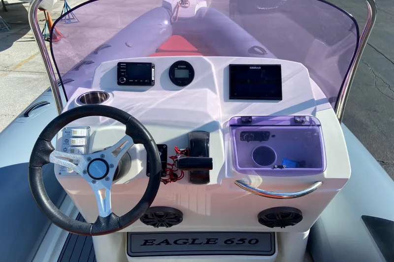 Slide: The Image of 2019 Brig Eagle 650 boat dashboard with steering wheel and navigation instruments. - 8