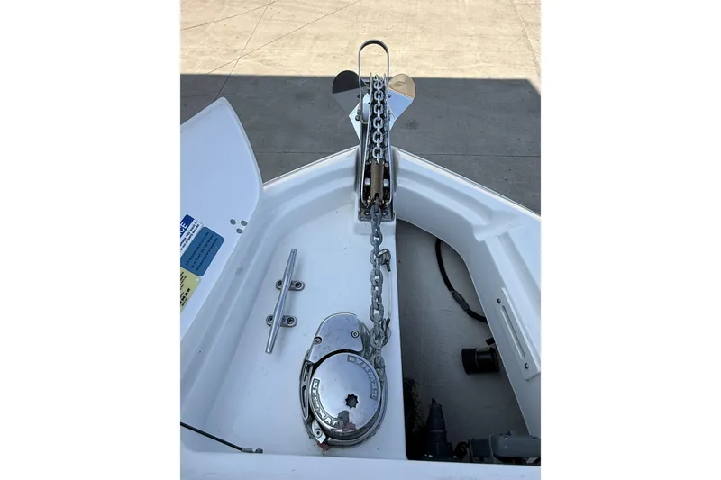 Slide: The Image of Anchor chain and windlass on 2021 Pursuit DC 235 Dual Console boat. - 11
