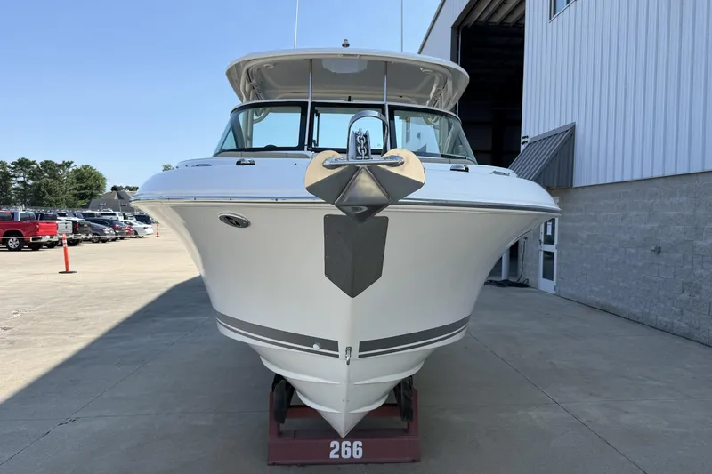 Slide: The Image of 2021 Pursuit DC 235 Dual Console boat on display outside a warehouse. - 2