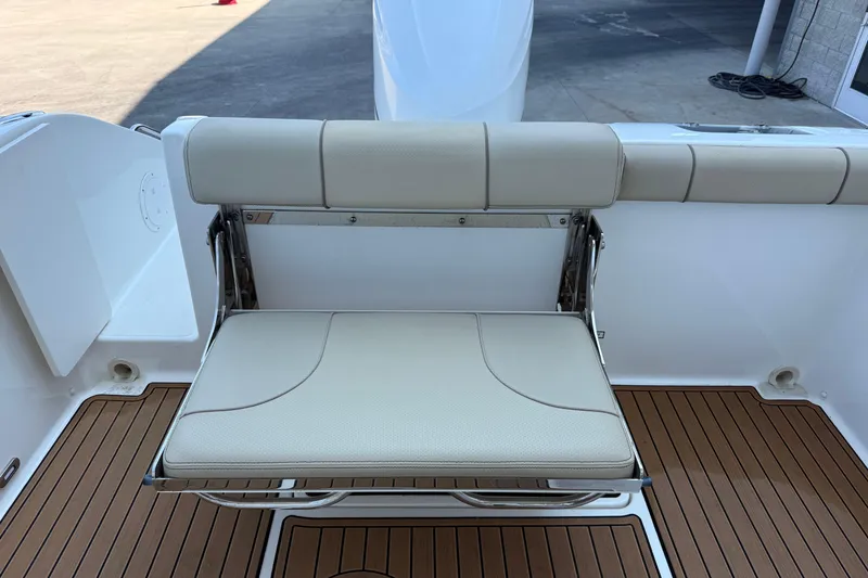 Slide: The Image of 2021 Pursuit DC 235 Dual Console boat seat with teak flooring, showcasing luxury design. - 13