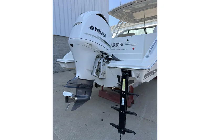 Slide: The Image of 2021 Pursuit DC 235 Dual Console boat with Yamaha outboard motor, docked outdoors. - 15