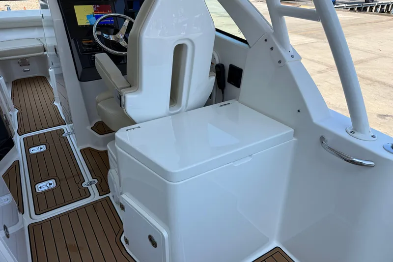 Slide: The Image of 2021 Pursuit DC 235 Dual Console interior with teak flooring and modern helm design. - 10