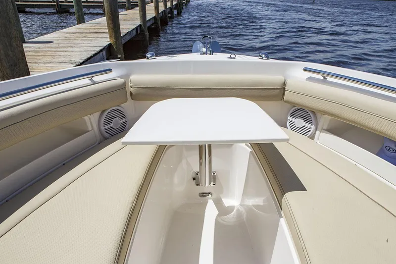 Slide: The Image of Manufacturer Provided Image: 2021 Pursuit DC 235 Dual Console boat interior with table and seating. - 18