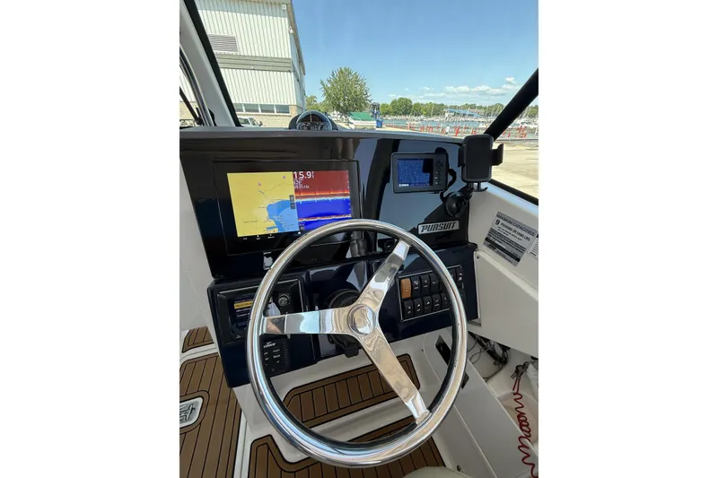 Slide: The Image of 2021 Pursuit DC 235 Dual Console helm with navigation display and steering wheel. - 4
