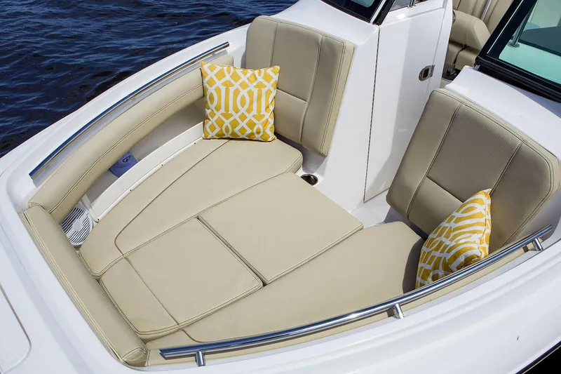 Slide: The Image of Manufacturer Provided Image: 2021 Pursuit DC 235 Dual Console boat with beige seating and yellow pillows. - 19