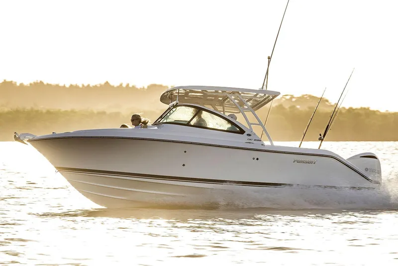 The Image of Manufacturer Provided Image: 2021 Pursuit DC 235 Dual Console boat cruising on water at sunset. - 20