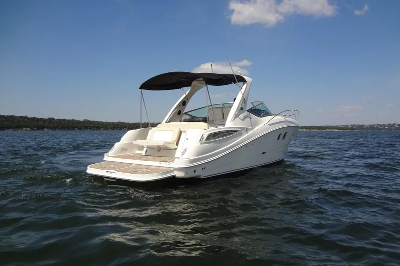 Slide: The Image of 2013 Sea Ray Sundancer 330 yacht on open water under clear sky. - 12