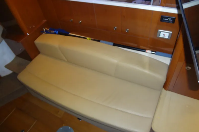 Slide: The Image of Interior of 2013 Sea Ray Sundancer 330 with beige leather seating and wooden cabinetry. - 39