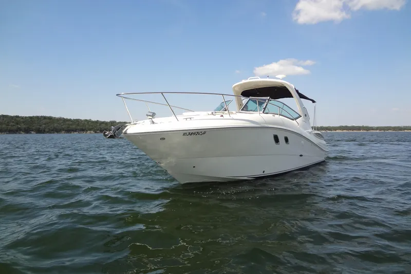 Slide: The Image of 2013 Sea Ray Sundancer 330 yacht on open water under clear blue sky. - 10