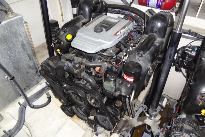 Slide: The Image of Engine compartment of a 2013 Sea Ray Sundancer 330 boat, showcasing the engine components. - 60
