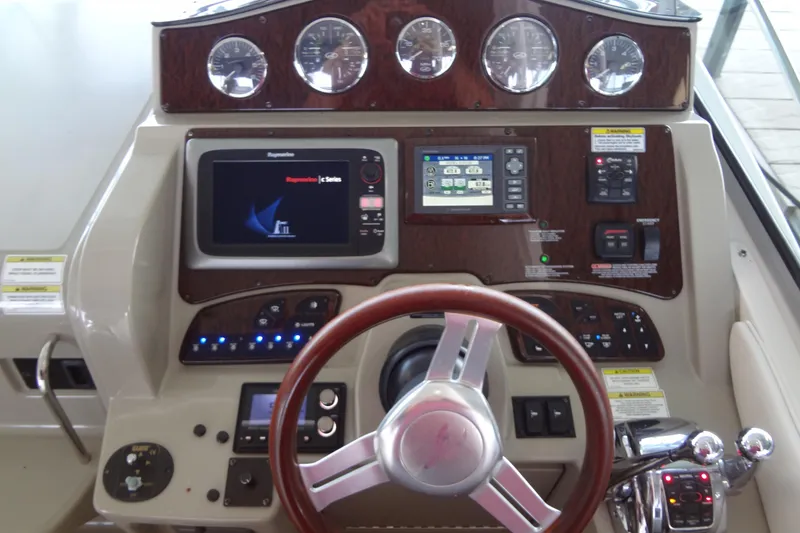 Slide: The Image of Dashboard of a 2013 Sea Ray Sundancer 330 boat with navigation controls and gauges. - 26