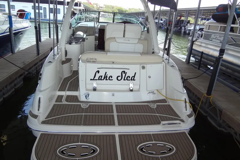 Slide: The Image of 2013 Sea Ray Sundancer 330 docked, featuring spacious deck and elegant design. - 13