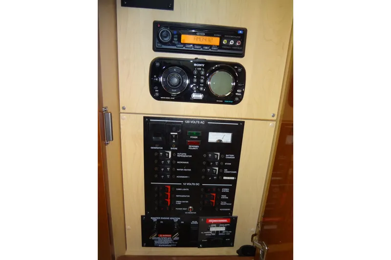 Slide: The Image of Control panel of a 2013 Sea Ray Sundancer 330 boat with audio system and electrical switches. - 52