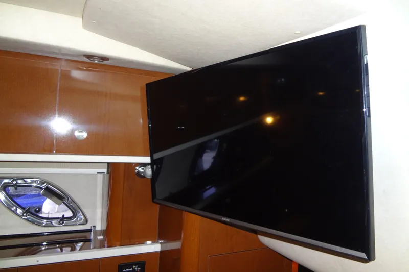 Slide: The Image of Interior of 2013 Sea Ray Sundancer 330 with mounted flat-screen TV. - 47