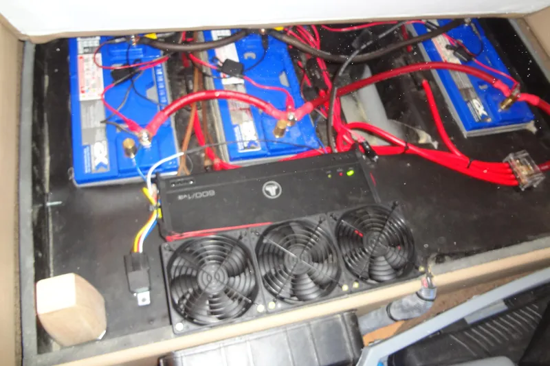Slide: The Image of Battery compartment of a 2013 Sea Ray Sundancer 330 with wiring and cooling fans. - 50