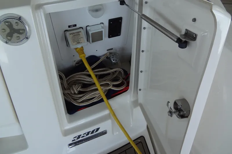 Slide: The Image of 2013 Sea Ray Sundancer 330 shore power connection with coiled rope and yellow cable. - 15
