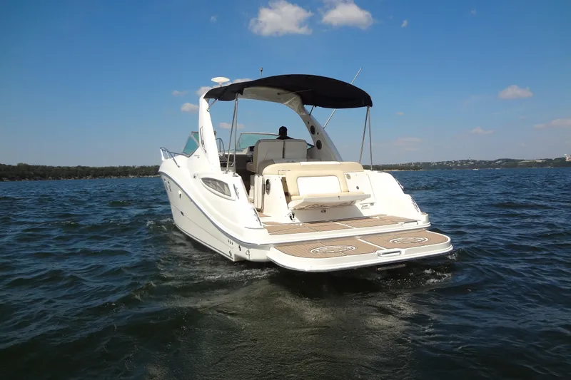 Slide: The Image of 2013 Sea Ray Sundancer 330 cruising on a sunny day, showcasing sleek design and spacious deck. - 5
