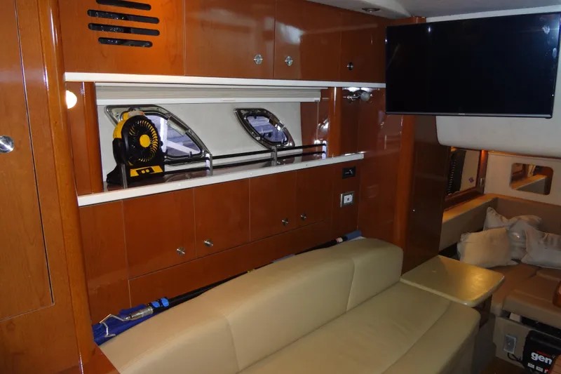 Slide: The Image of Interior of 2013 Sea Ray Sundancer 330 yacht with wooden cabinetry and beige seating. - 46