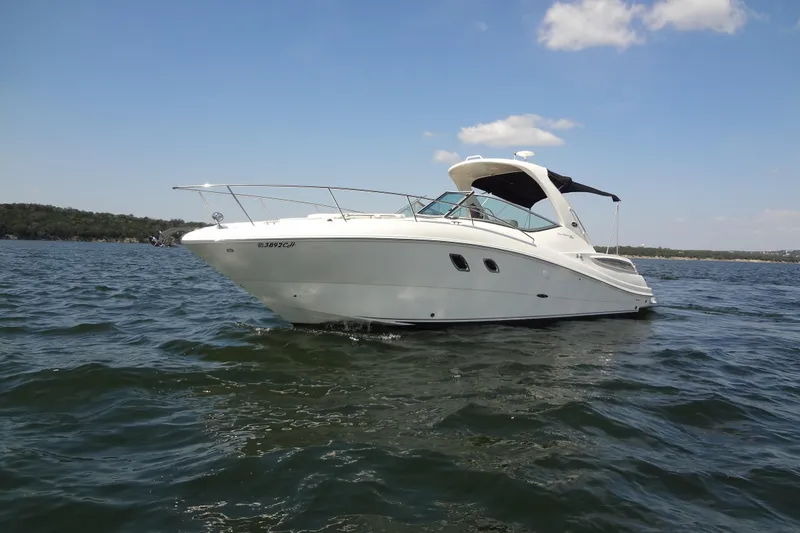 Slide: The Image of 2013 Sea Ray Sundancer 330 yacht cruising on open water under clear skies. - 9